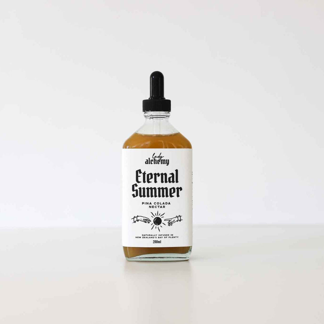 Bottle of 'Eternal Summer' Pina Colada Fruit Salad Nectar with a dropper on a white background